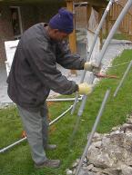 The 1.25" conduit slides down over the metal rods